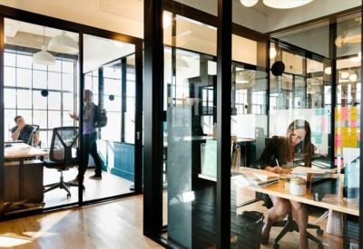 Private office suites with glass walls and professional workstations.