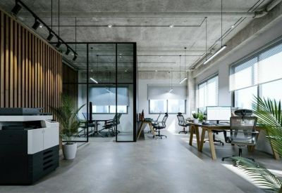Industrial style office featuring exposed concrete ceilings and a wooden slat feature wall.