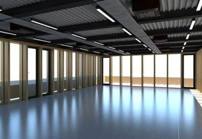 Spacious open-plan workspace with dark beamed ceilings and wall-to-wall windows.