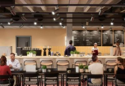 Communal cafe and dining area with a long service counter, high stools, and industrial lighting.