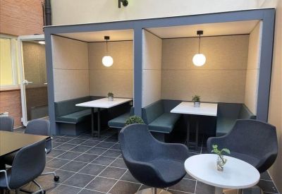 Built-in seating booths with pendant lights in a common area.