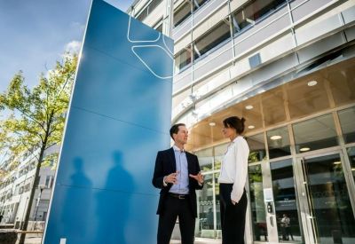 Exterior of Johan Willins gata 2-8, Ullevi, Gothenburg with a large blue sign and glass facade.
