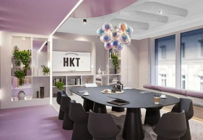 Stylish meeting room with a large oval table, purple accents, and a bubble-glass chandelier.