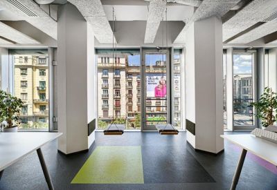 Modern breakout space featuring indoor swings and large windows.