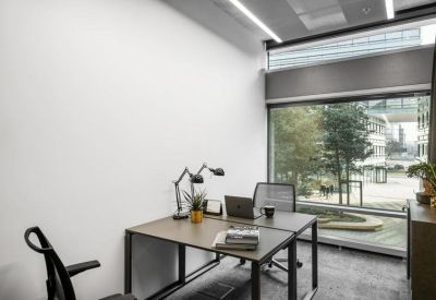 Private office suite with two desks and a large window overlooking a courtyard.