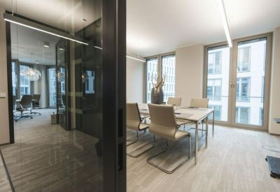 Small meeting room with glass walls and large windows for natural light.