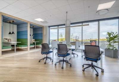 Semi-private meeting booths with colorful acoustic panels and pendant lighting.