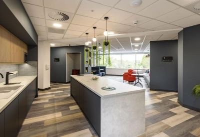 Communal kitchen area with modern design and island counter.