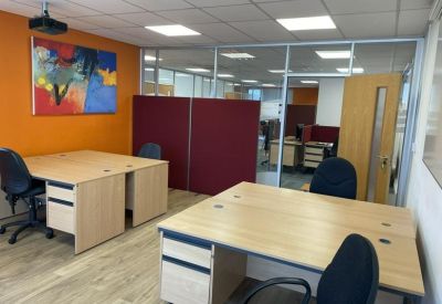 Two-person meeting room with colorful artwork on the wall.