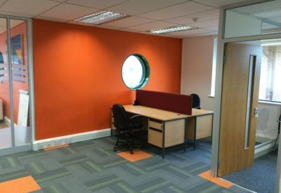 Workspace with desk next to a circular window.