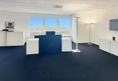 Spacious reception area with a blue and white front desk.