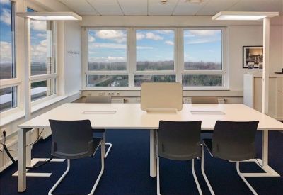Four-person workstation with integrated lamps and large windows.