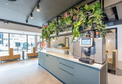 Modern kitchen station featuring a professional coffee machine and wooden accents.