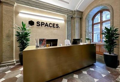 Branded reception desk with gold-toned paneling and marble flooring.
