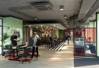 Modern communal lounge and coworking area with colourful furniture, plants, and cafe seating.