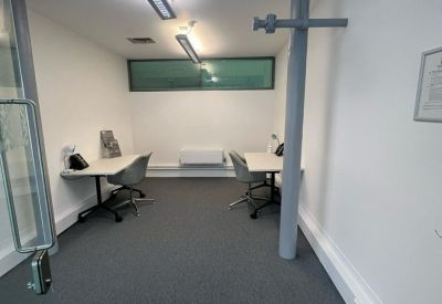 Private office suite featuring two desks and modern linear lighting.