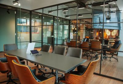 Boardroom with a long table and glass partition walls.