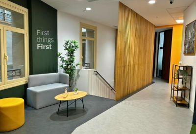 Professional reception desk with a deep blue feature wall and wood accents.