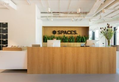 Professional reception area with a large light-wood desk and branded signage.
