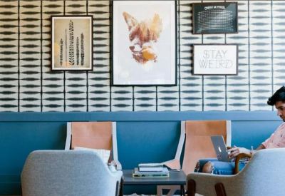 Cozy coworking area with a patterned feature wall and comfortable seating.