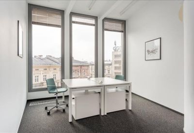 Private office suite with two white desks and views of the surrounding historic architecture.