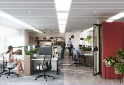 Collaborative workspace with a modern red phone booth and various desk configurations.