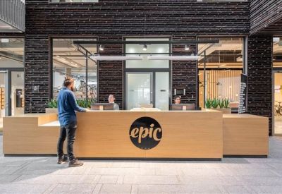 Bright reception area featuring a light wood desk with an Epic logo.