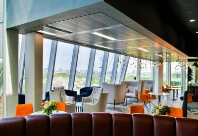 Contemporary breakout space with various lounge seating and views of the London skyline.