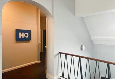 Interior hallway with an arched entrance leading to rooms and an HQ sign on the wall.