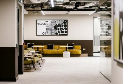 Modern lobby area with low-slung armchairs and abstract wall art.