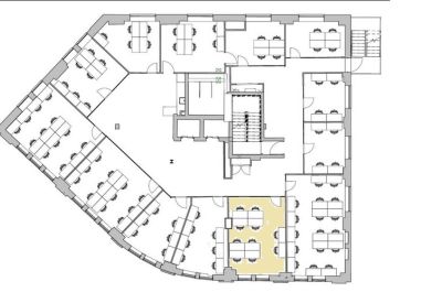 Private office room with four white desks and light gray flooring.