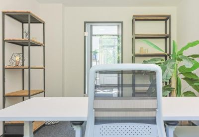 Office space with white desk and shelving.