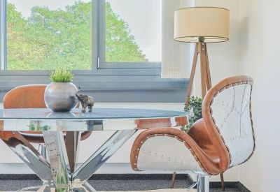 Meeting area with a round table and leather chairs.