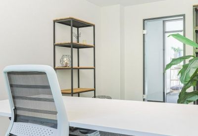Private office with white desk and modern chair.