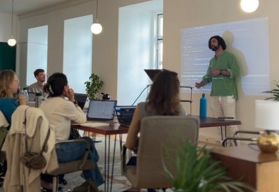 Presentation taking place in an airy office with high ceilings and minimalist decor.