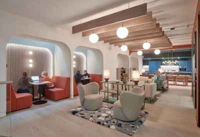 Stylish lounge area with arched nooks, red booth seating, and globe pendant lights.