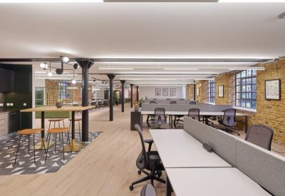 Industrial-style open office with exposed brick walls and black structural columns.