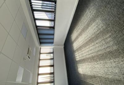 Brightly lit white office space with window views.