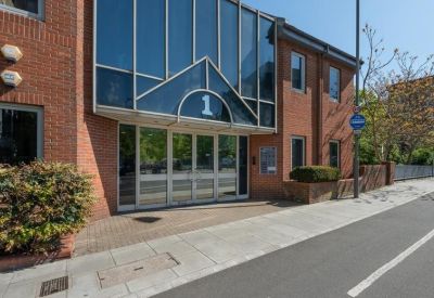 Close-up of the main glass entrance with building number 1 clearly displayed.