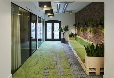 Sunny outdoor terrace with patio tables, umbrellas, and hanging chairs.
