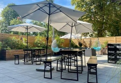 Large professional meeting room with a long table and whiteboard screen.