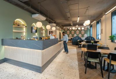 The stylish cafe and coworking hub at 105, Ferensway featuring green walls and a marble-topped counter.