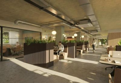 Open-plan office with partitioned booths and glass-walled meeting rooms.