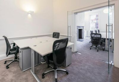 Private office suite with glass doors leading to a separate meeting area.