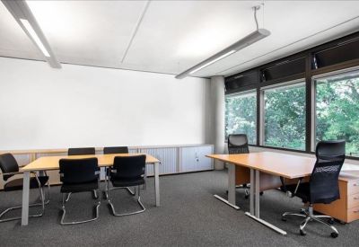 Private office suite with two wooden desks and large windows.