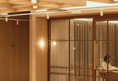 Private office pod with a glass door and warm internal lighting.