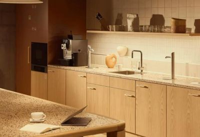 Modern wooden kitchen area with integrated appliances and tiled flooring.