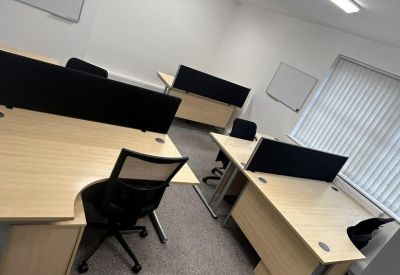Modern open-plan office suite with multiple desks and ergonomic chairs.