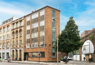Exterior view of the brick facade at 115, Southwark Street near a modern railway arch.