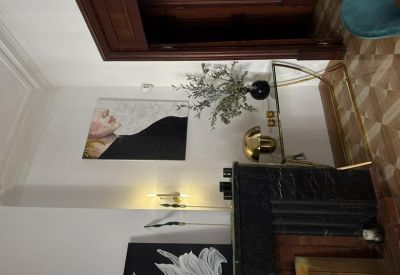 Artistic entryway with a black console table and modern portrait painting.